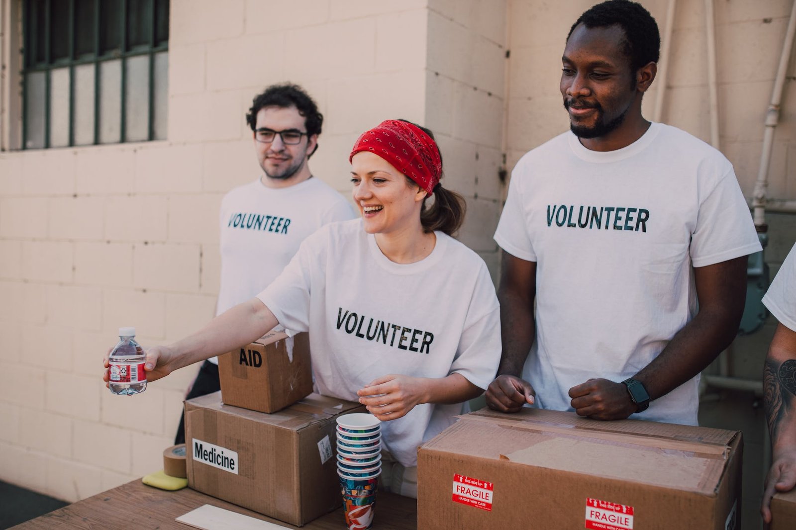 Three People Donating Goods